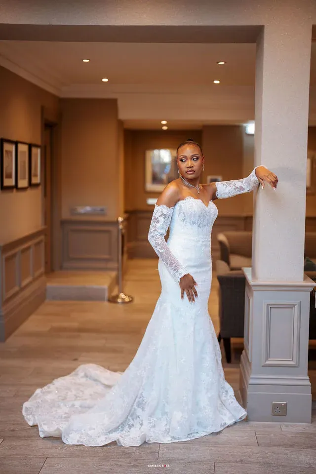 Remi in her wedding dress framed by a doorway