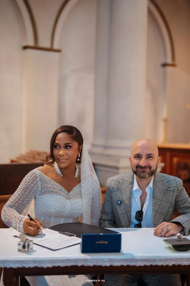 The couple seated together at the signing table. CameraBoss portfolio: Cynthia and Oswaldo.