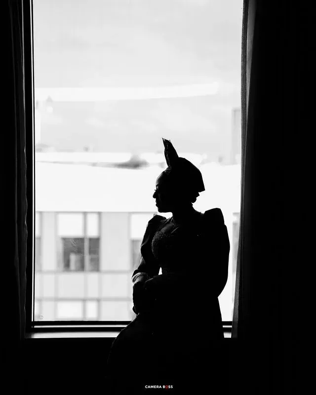 A silhouette portrait beside a bright window. CameraBoss portfolio: Tolu Prewedding Birmingham.
