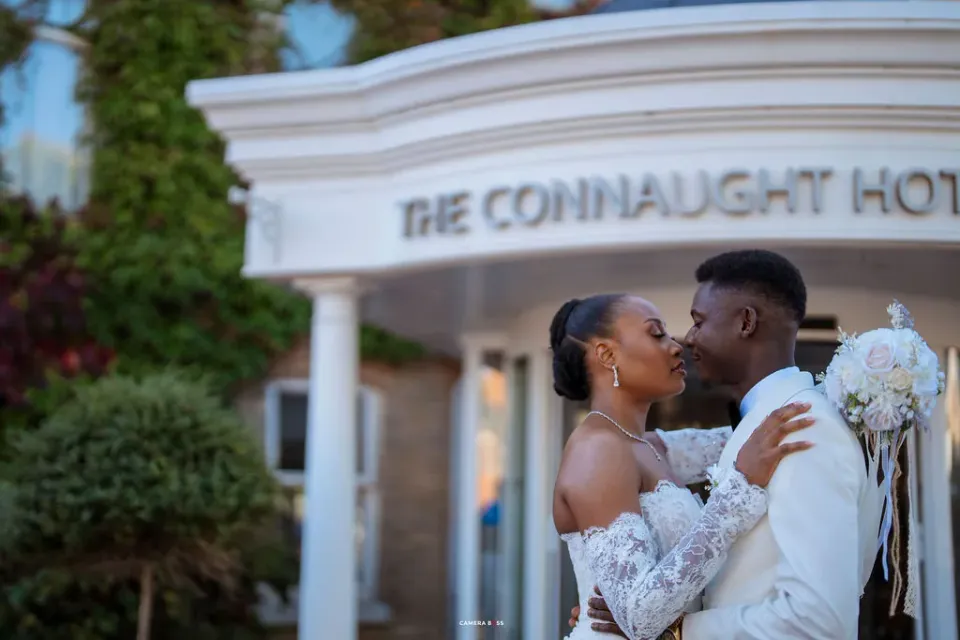 Remi and Daniel kissing outside The Connaught Hotel