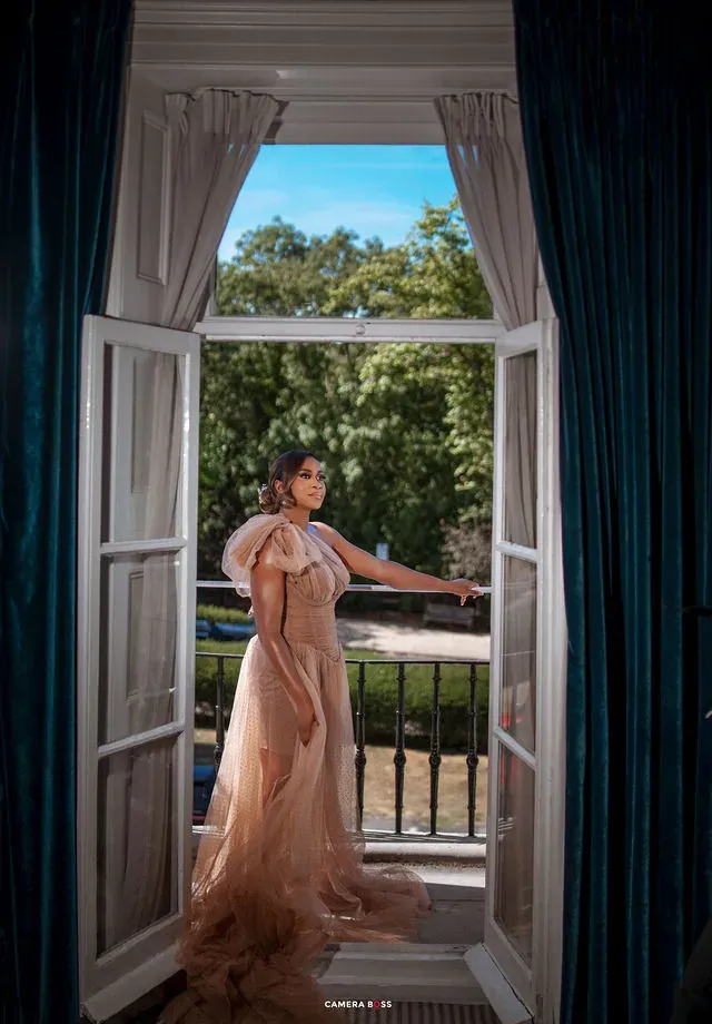 Bridal portrait framed by an open balcony doorway. CameraBoss portfolio: Cynthia and Oswaldo.
