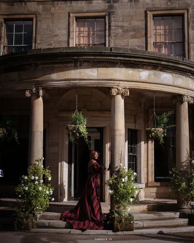 Jo framed by the deep entrance and stone columns. CameraBoss portfolio: Jo and Jonny.