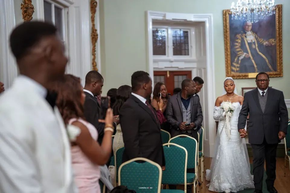 Remi arriving in the ceremony room with a guest