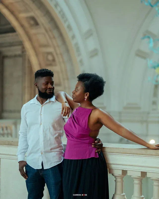 A couple in a pre-wedding portrait beside an interior railing. CameraBoss portfolio: Tomilayo Prewedding London.