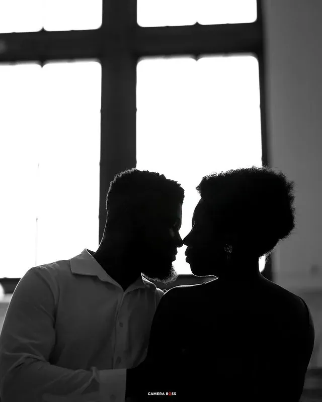 A couple silhouetted against a bright window. CameraBoss portfolio: Tomilayo Prewedding London.