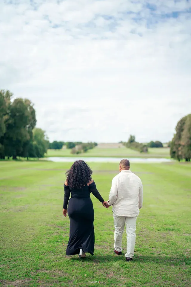 A couple walking away hand in hand. CameraBoss portfolio: Oney Prewedding at Boughton House.