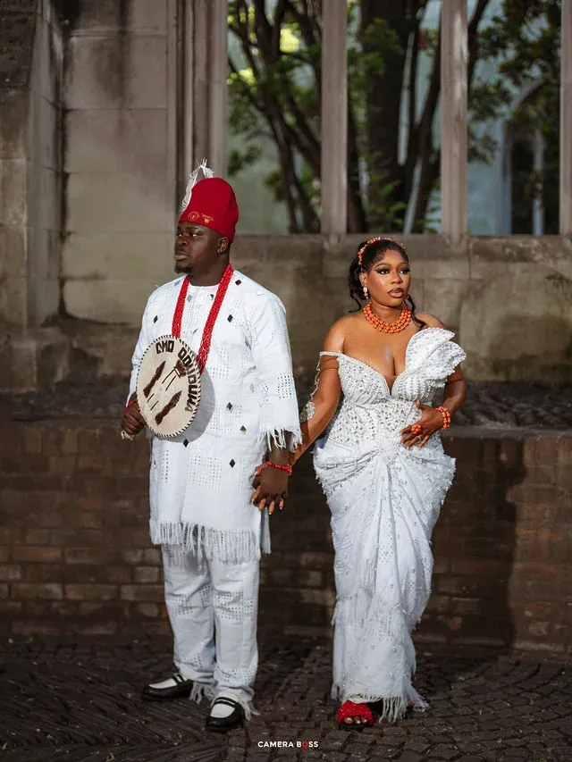 A couple holding hands in white formal attire. CameraBoss portfolio: Korede Prewedding.