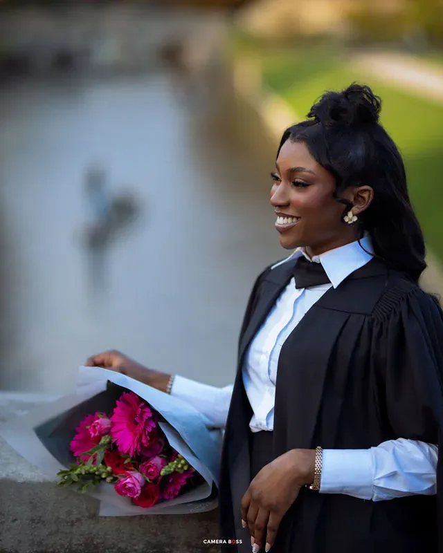 A close graduation portrait with flowers and an academic cap. CameraBoss portfolio: Peters Grad.