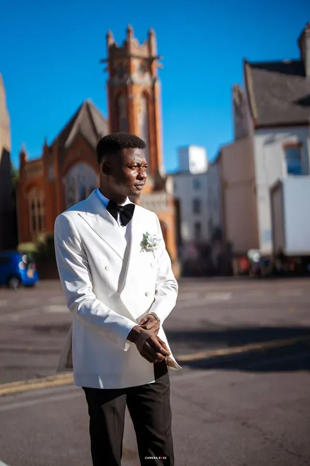 A portrait of Daniel in his white jacket and black bow tie. CameraBoss portfolio: Remi and Daniel’s Bournemouth civil wedding.