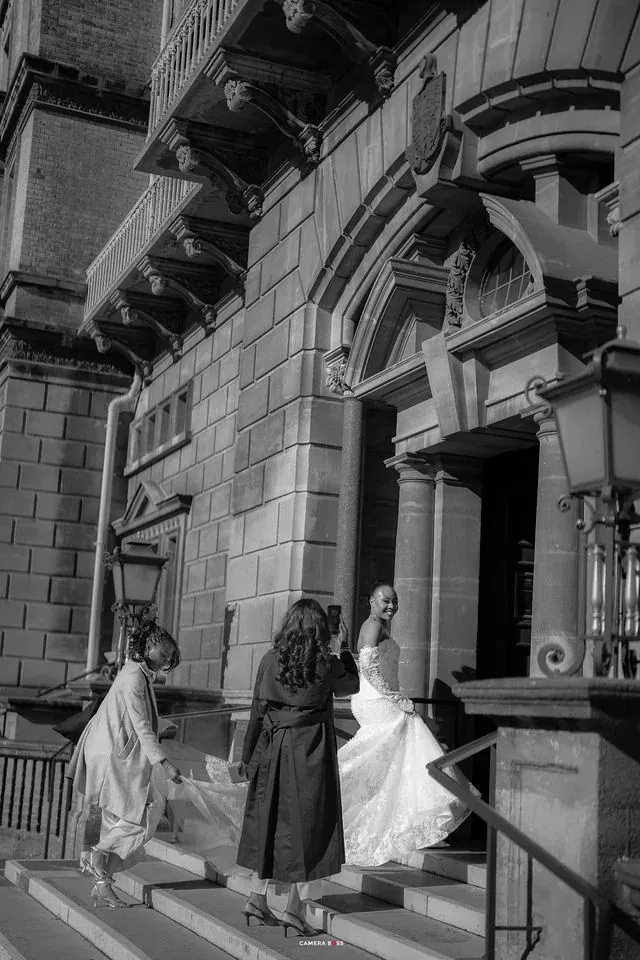 Remi and bridesmaids beneath the stone entrance. CameraBoss portfolio: Remi and Daniel’s Bournemouth civil wedding.