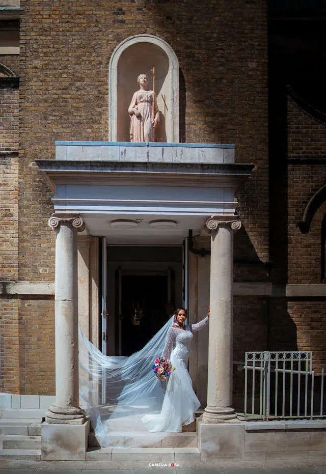 A bridal portrait with the veil flowing across the steps. CameraBoss portfolio: Cynthia and Oswaldo.