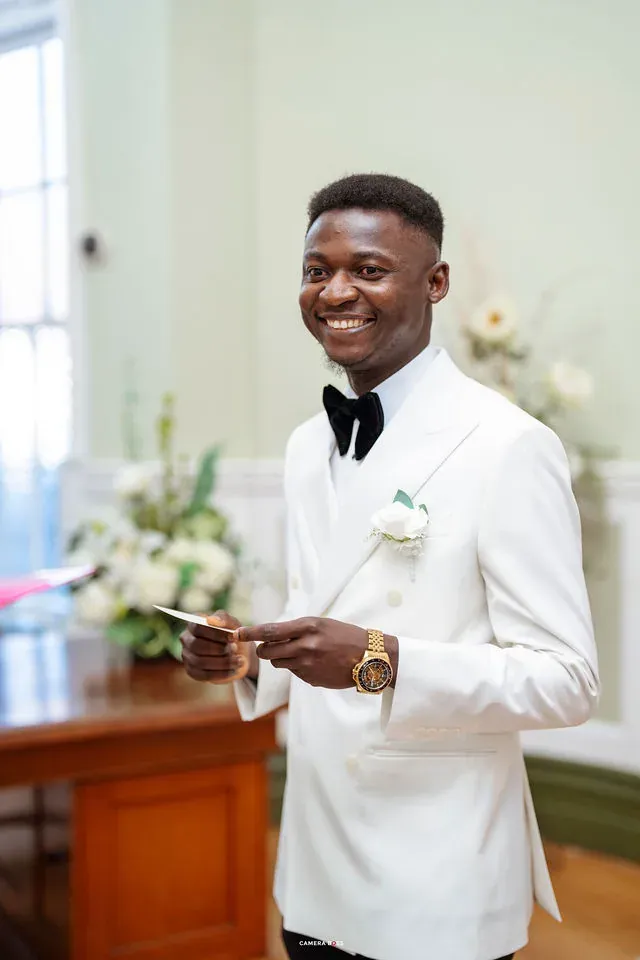 Daniel smiling with a card in his hands during his vows. CameraBoss portfolio: Remi and Daniel’s Bournemouth civil wedding.